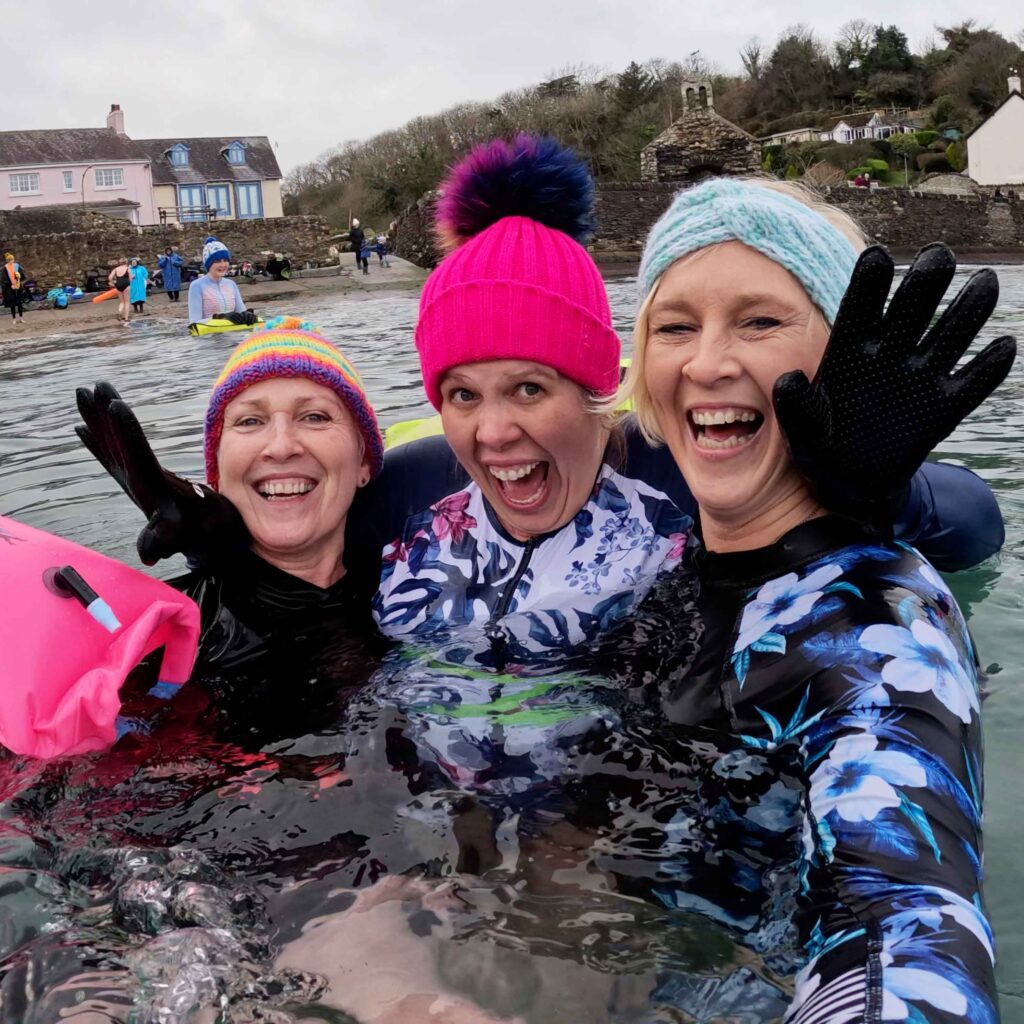 3 friends enjoying the benefits of a weekly wellbeing in Pembrokeshire and cold water immersion together.