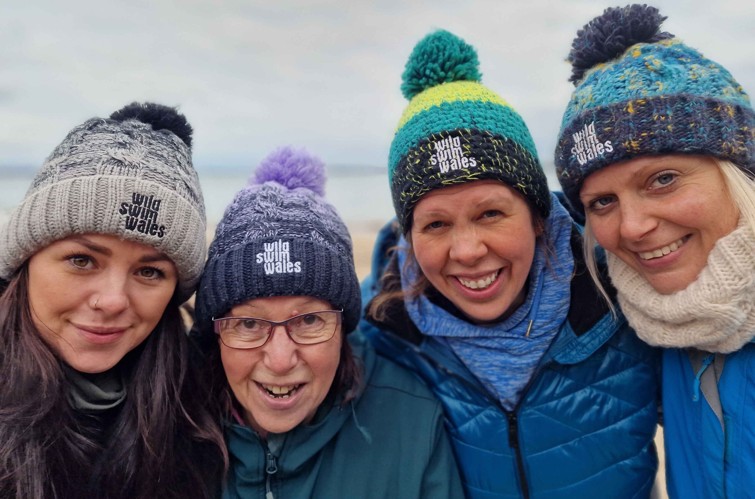 Swimmers wearing Wild Swim Wales woolly hats<br />
